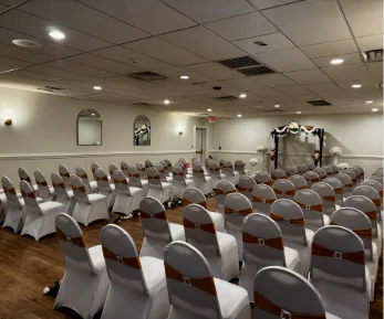 A wedding ceremony decorated in a ballroom